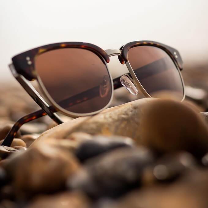 A pair of eco sunglasses on a beach