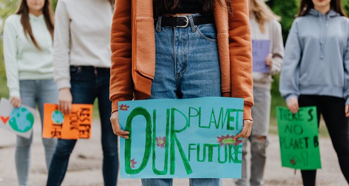Activist holding an "our planet, our future" sign