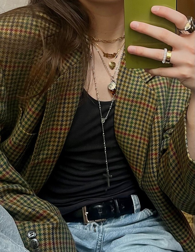 Consumer accessorising the garments inside their seasonless wardrobe