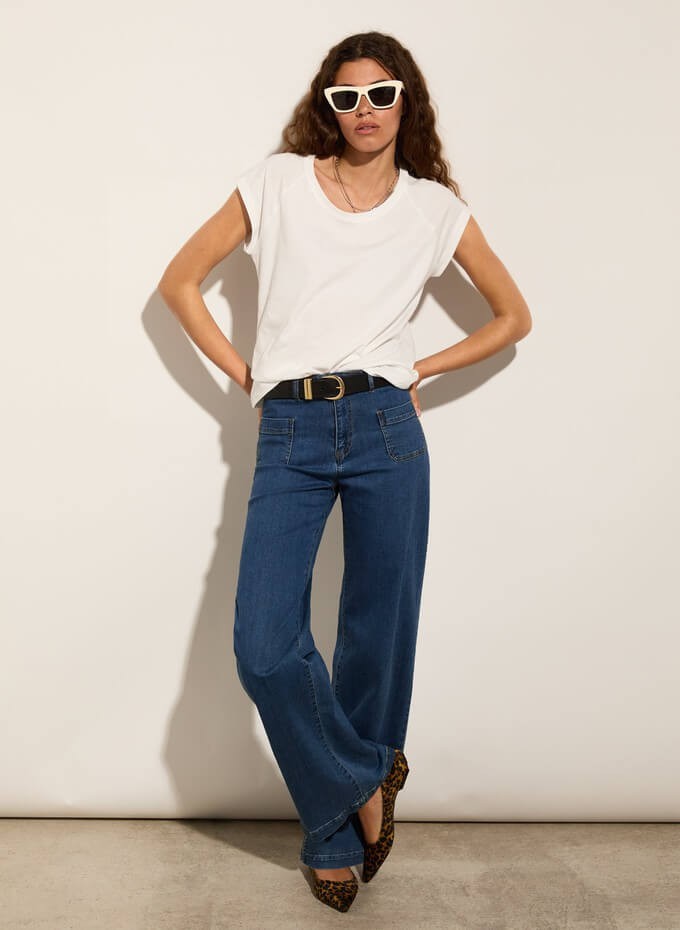 Consumer wearing a white tshirt as a sustainable summer essential