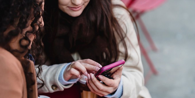 Consumer using their phone to send feedback to an ethical fashion brand