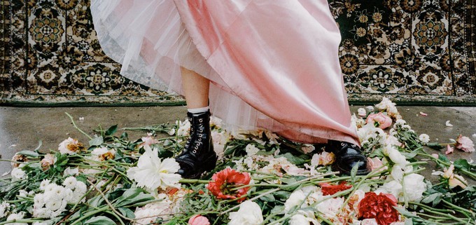 Consumer stepping in front of some flowers to show they're going to fight the environmental impact of these human activities