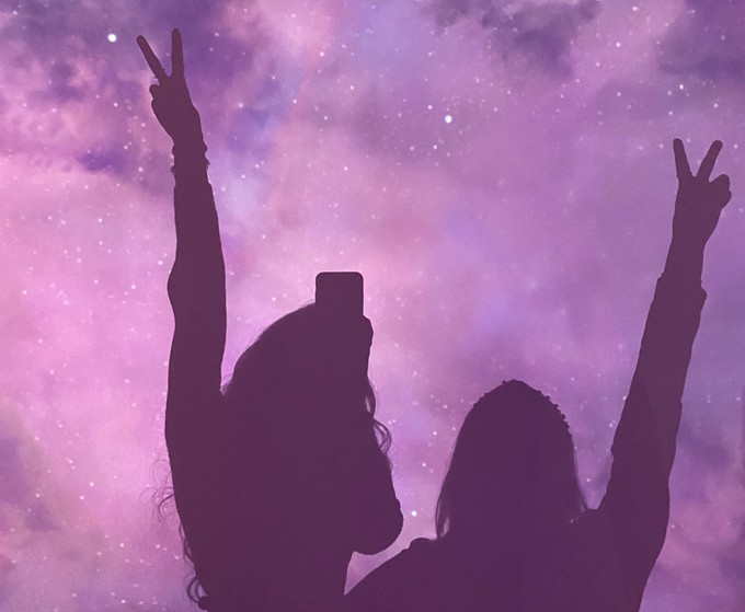 Silhouettes against a purple night sky to symbolise the connection between fashion and astrology