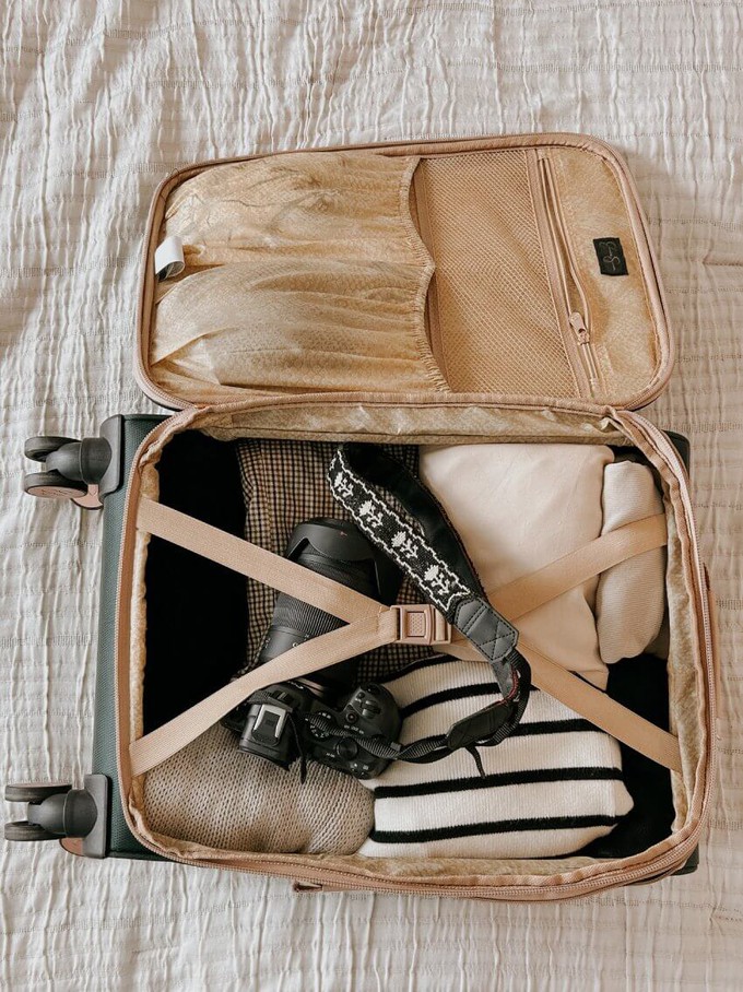 Suitcase filled with sustainable travel clothes