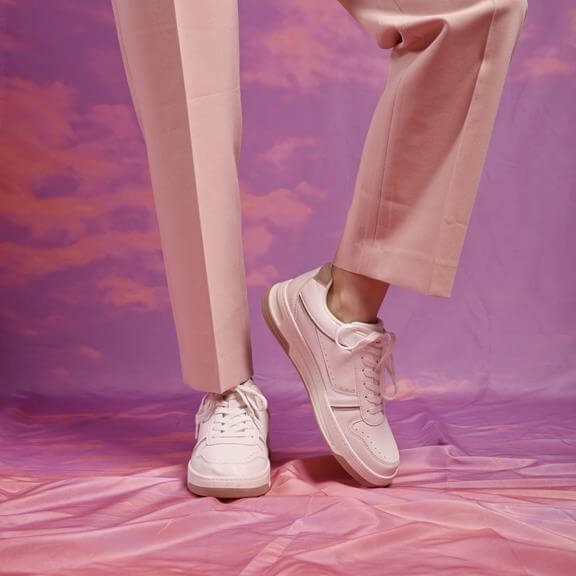 Versatile white trainers for a capsule wardrobe in autumn