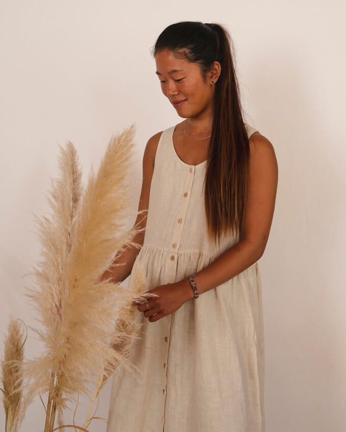 Woman wearing a linen dress made with one of the most sustainable fabrics