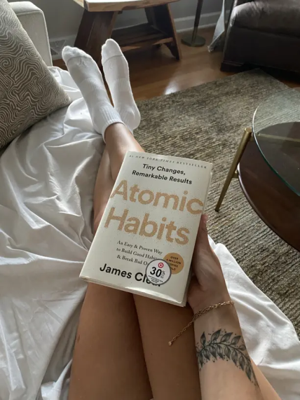 Happy consumer reading a book about breaking habits